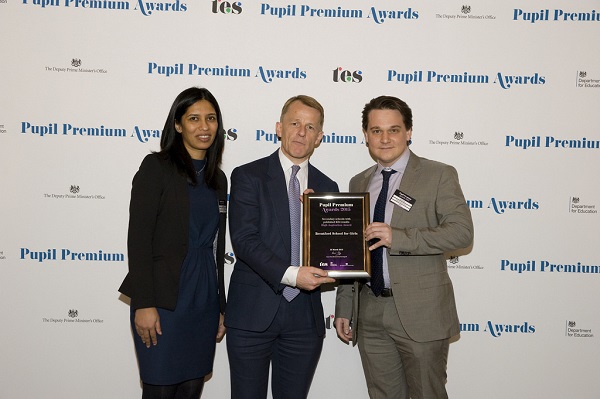 Brogen Thorpe and Devesha Singh receiving the award from David Laws