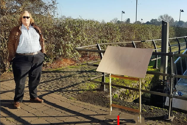 Councillor Guy Lambert next to the planned Ferry Wharf panel