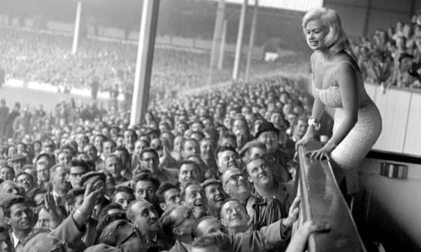 Jayne Mansfield draws the attention of Tottenham Hotspur fans at White Hart Lane in 1959.