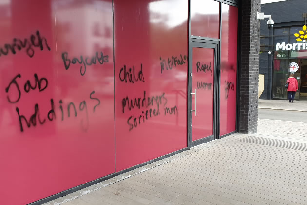 Grafitti on the front of the Pret store with obscenities blurre